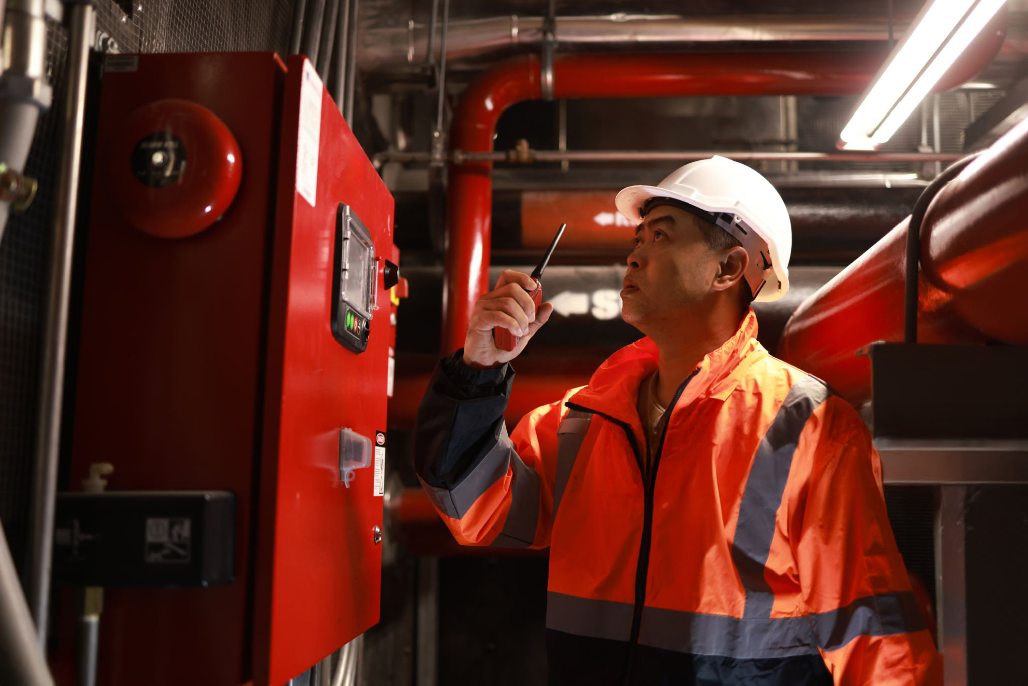 The engineer inspects the safety equipment on the fire extinguishing system.